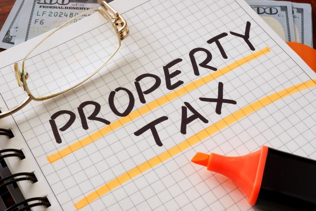 Notebook with property tax sign on a table.