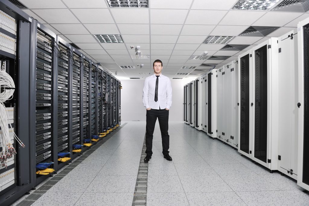 Employee standing in the middle of the server room
