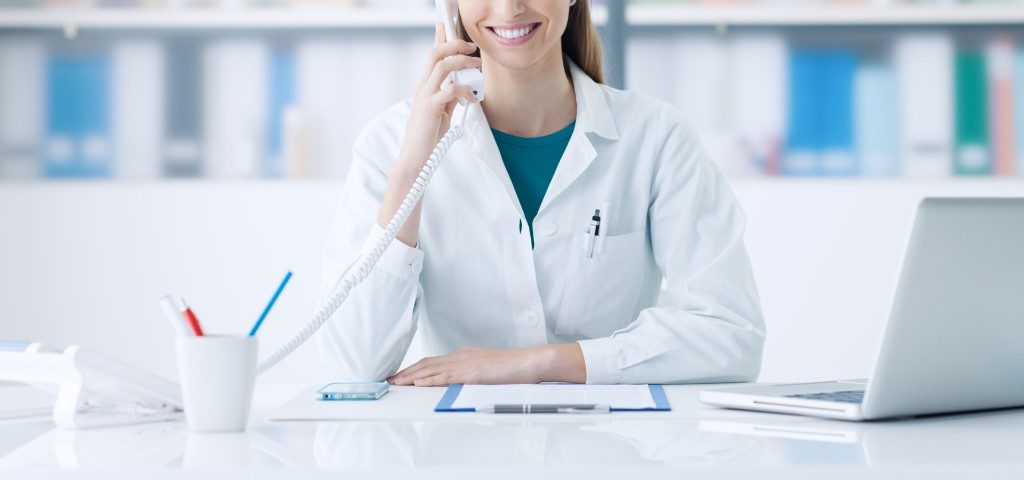 Doctor smiling at her desk