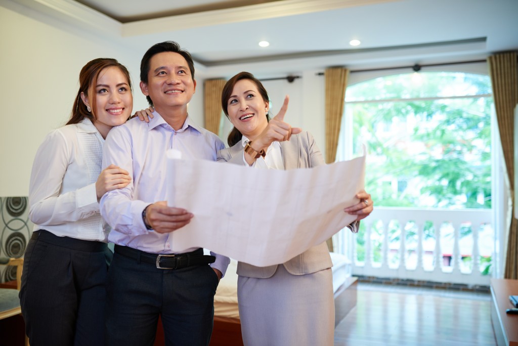 Broker showing a house to a couple