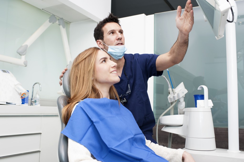 dentist showing an x-ray to his patient