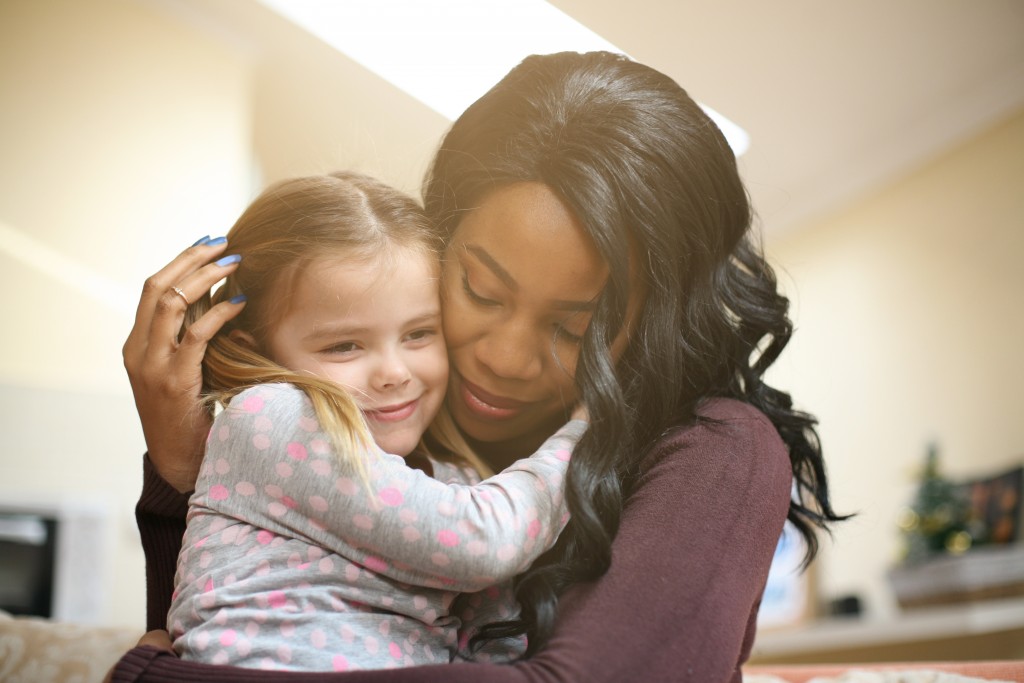 African American woman playing with girl