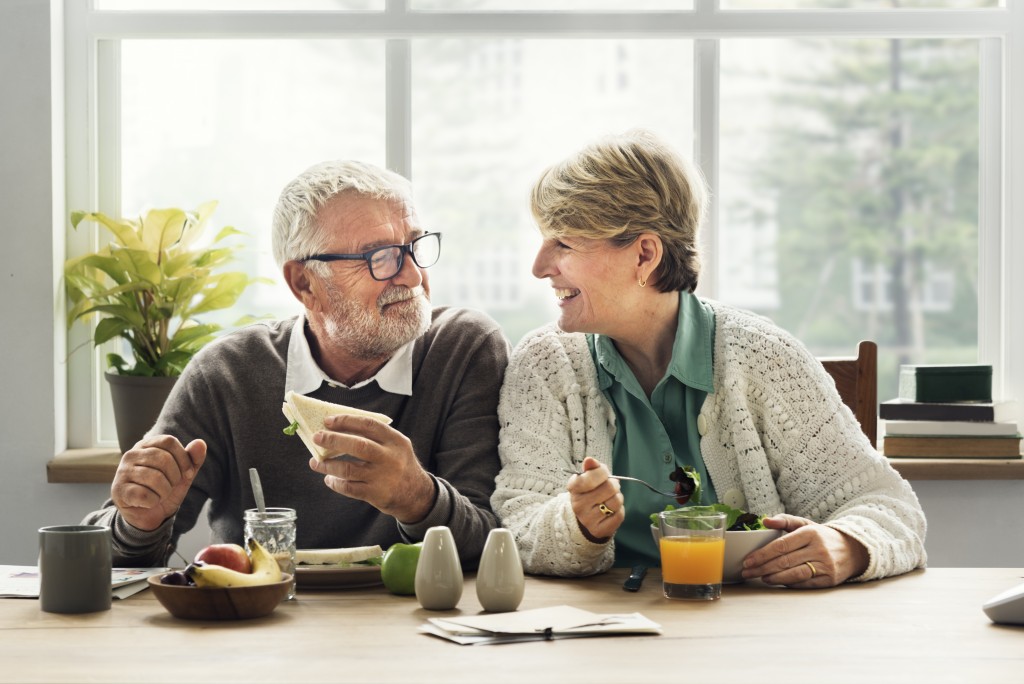 elderly couple eating together