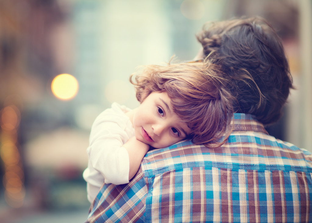 Little Girl resting on her father's shoulder