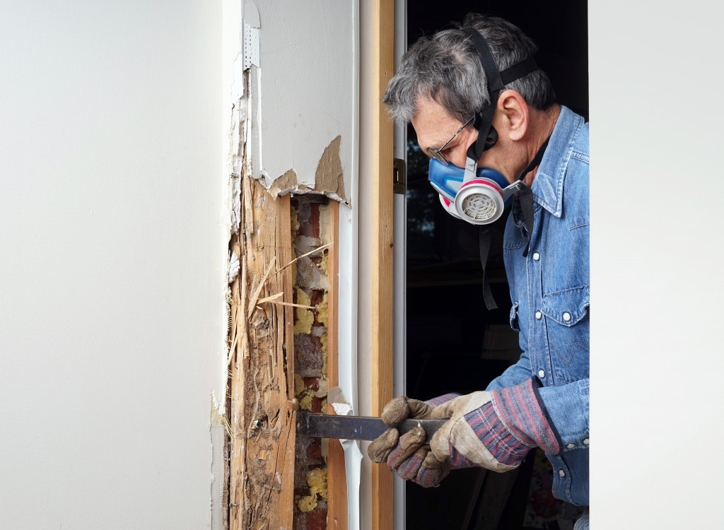 man destroying wall