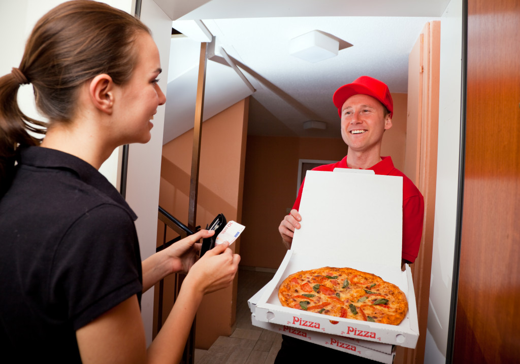 man delivering pizza to customer