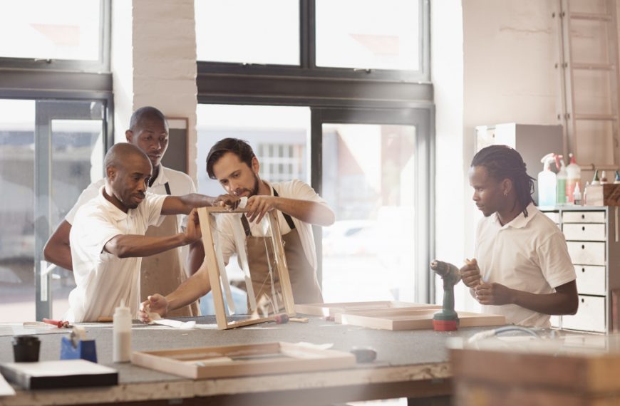 Carpenters working together on a wooden frame