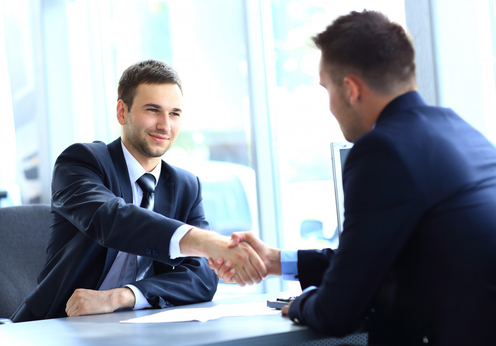 businessman shaking hands to seal a deal with his partner