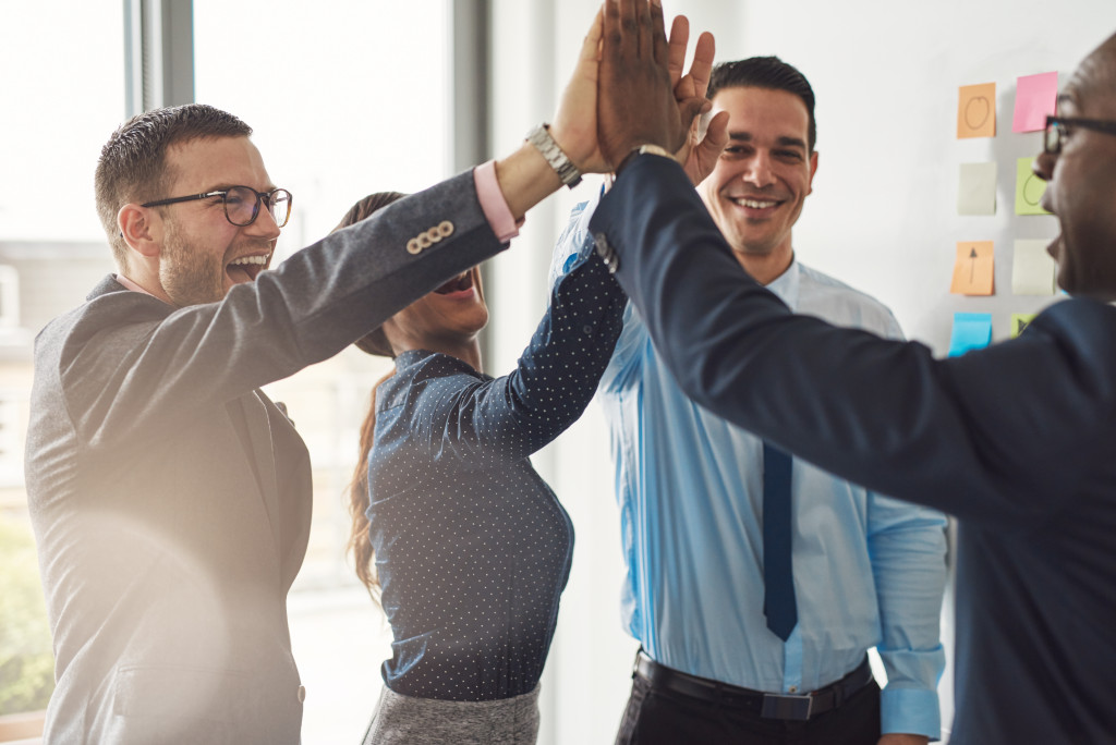 Group of employees having a high five