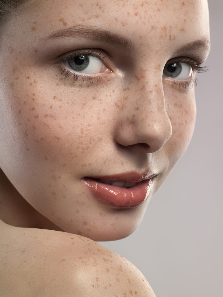 Close-up of young woman with freckles