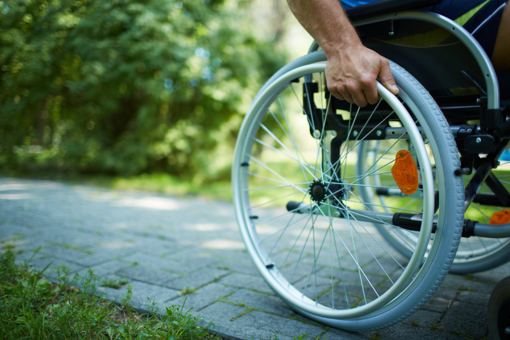 A man with disability pushing his wheelchair