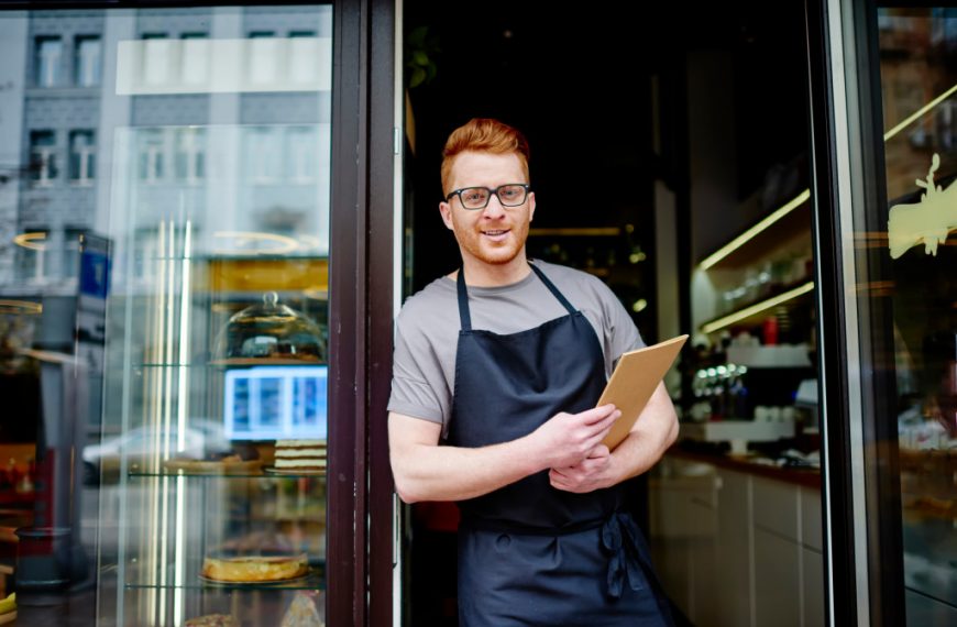 businessman standing in front of his grocery store