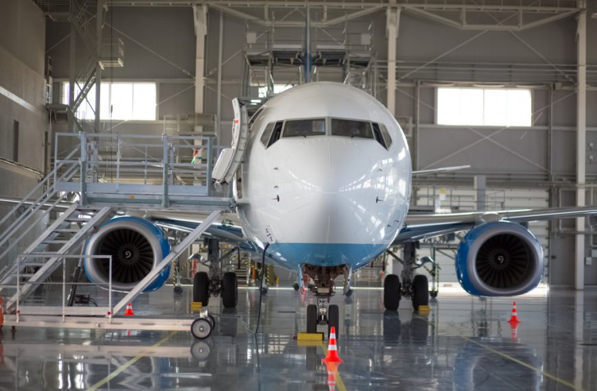 an aircraft with a ladder and cones on the sides and in front of it