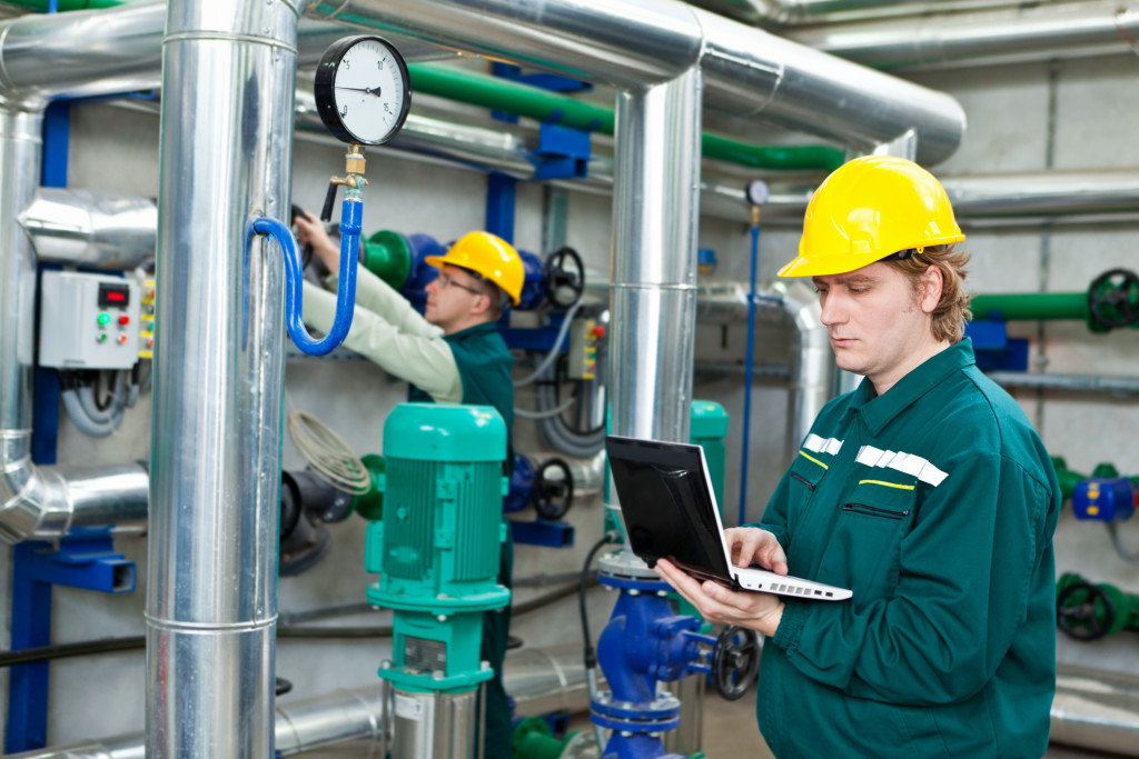 Male technician checking the equipment in a factory.