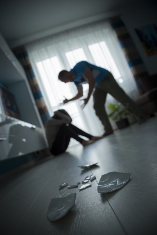 a man screaming at his wife on the floor