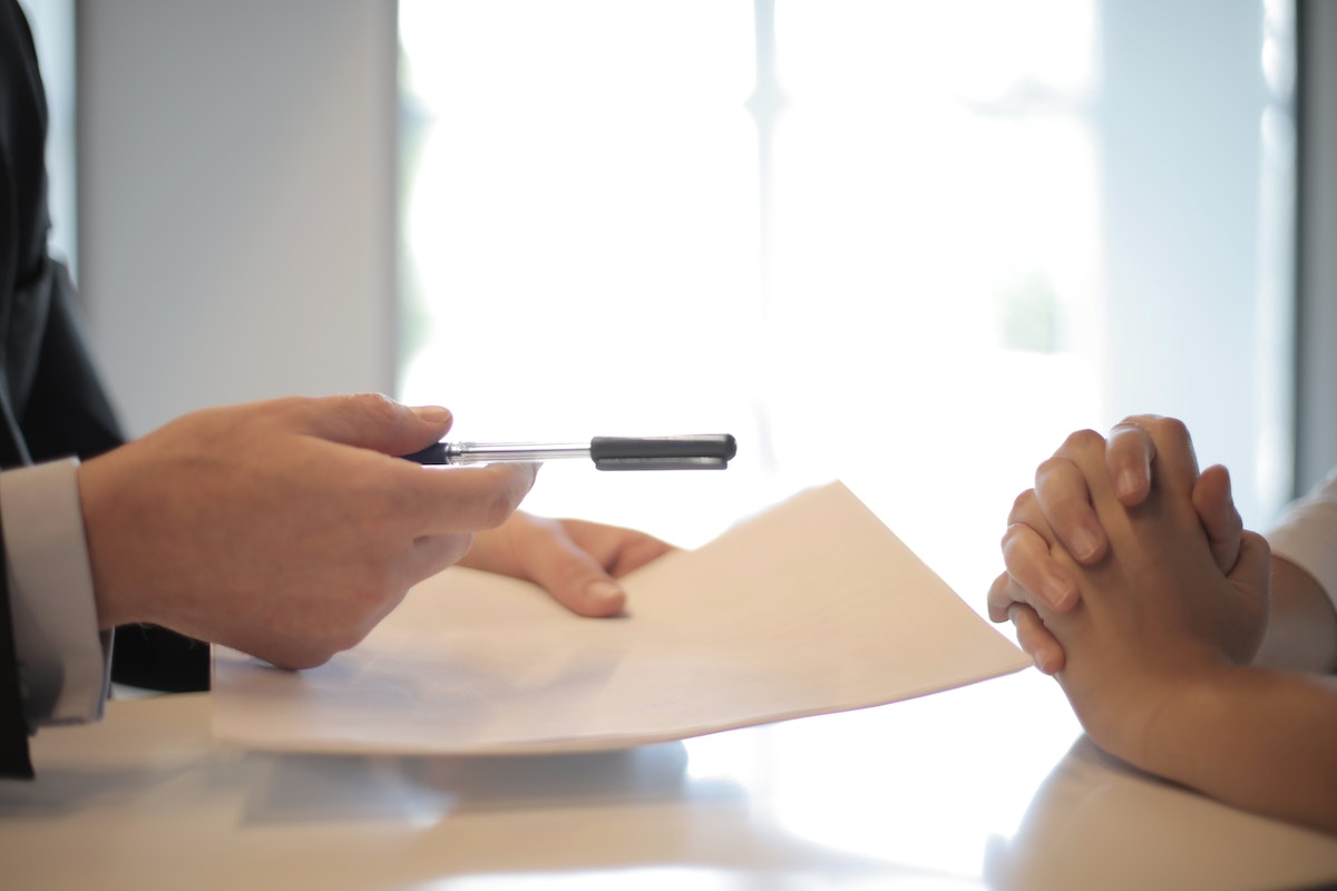 two people dealing with a legal document