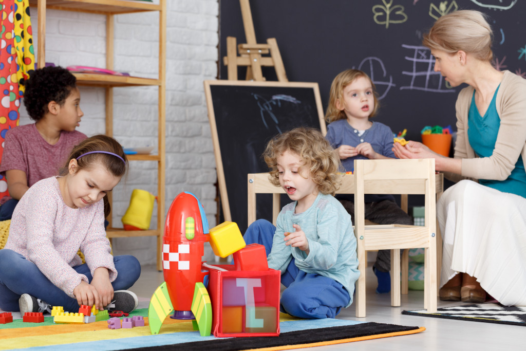 woman talking to children in a childcare facility