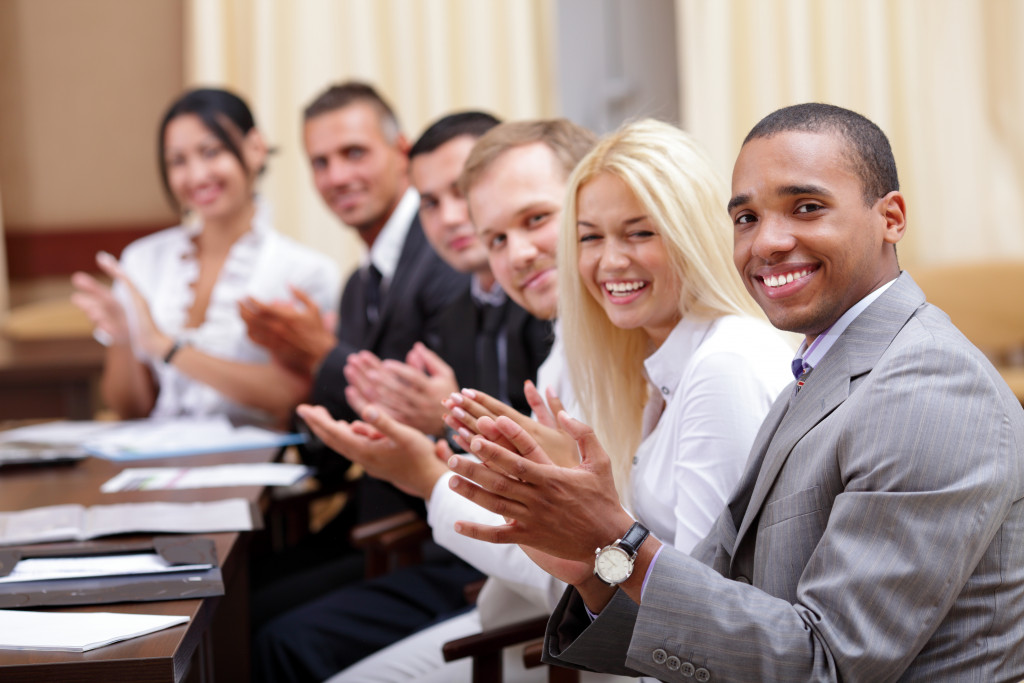 employees clapping in the conference room