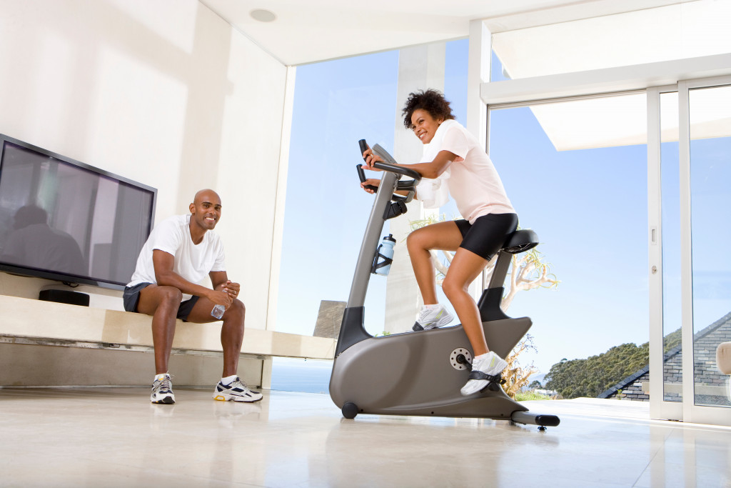 a couple exercising at a home gym