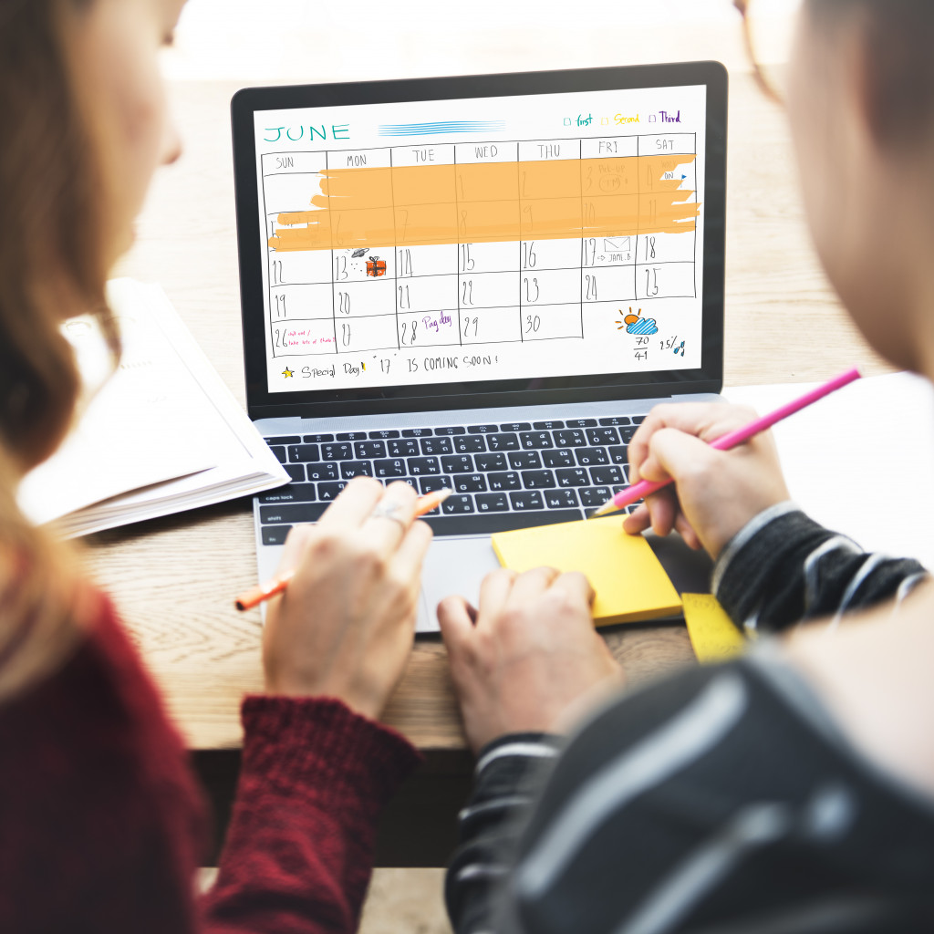 a manager fixing schedules on a calendar