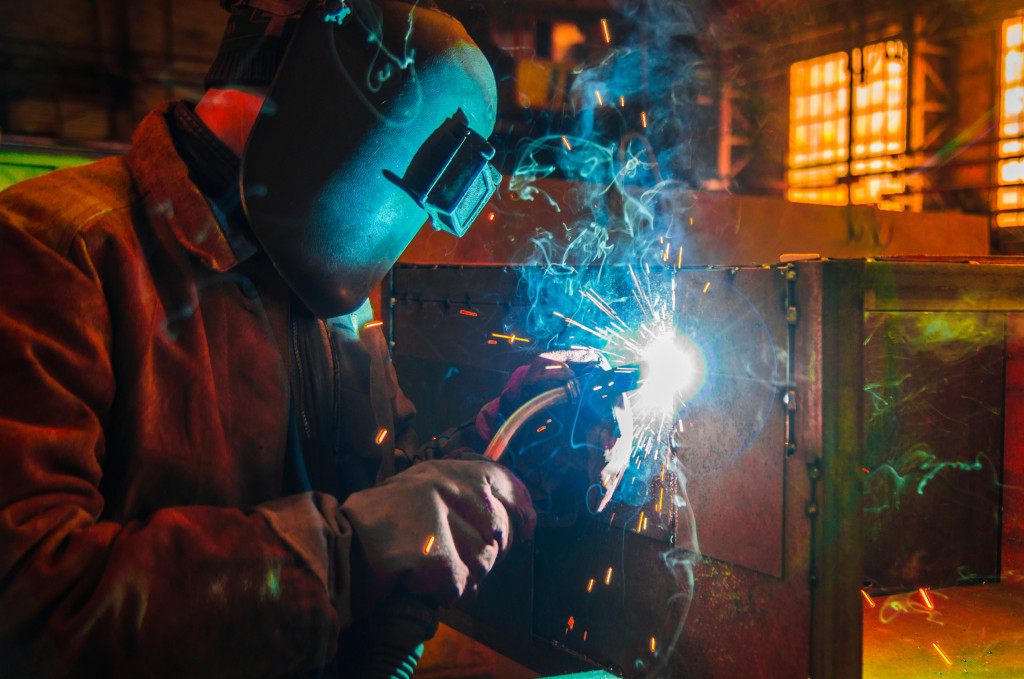worker with welding helmet