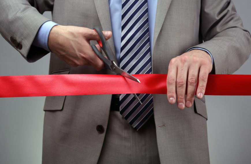 businessman cutting the ribbon