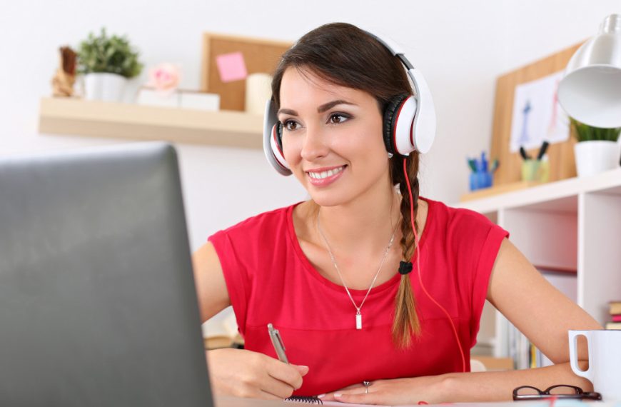 woman on her laptop wearing headset