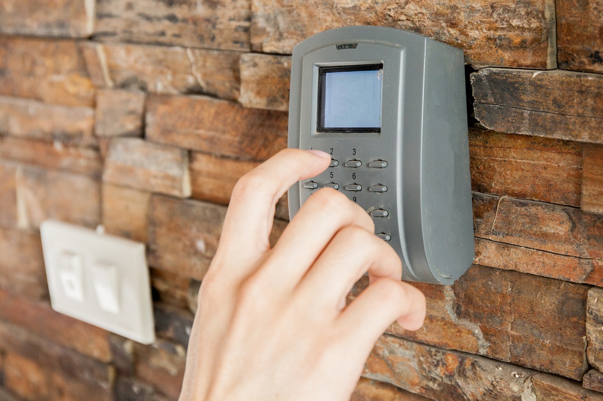 a person pressing security combination code