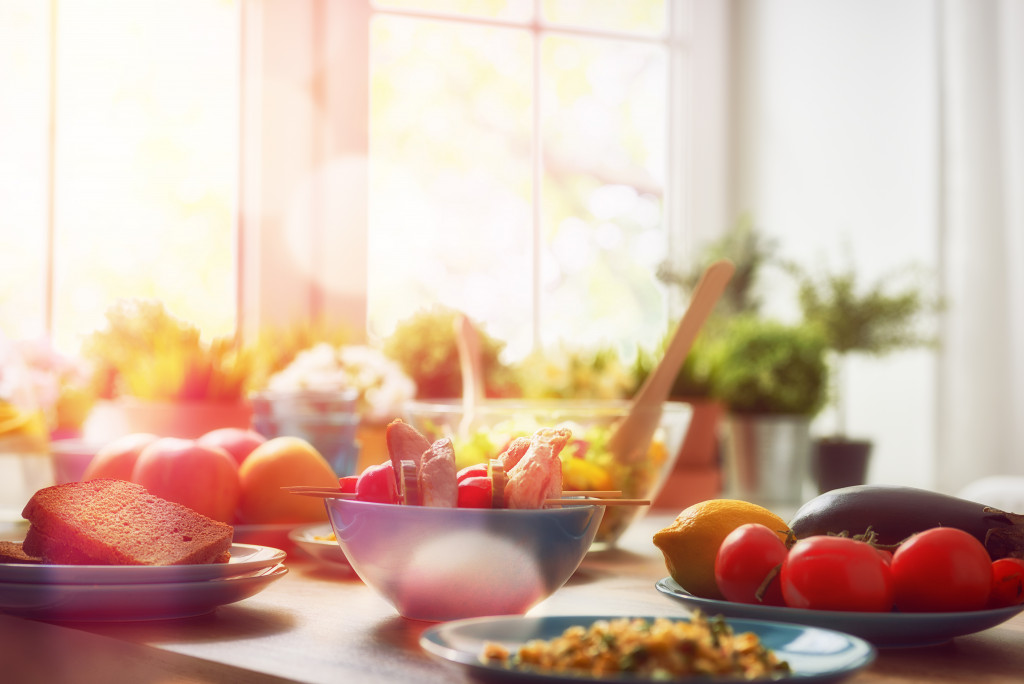 Healthy food on a table with bread, fruits, and vegetables/