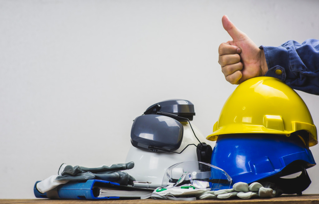 PPE and a hand showing a thumbs up