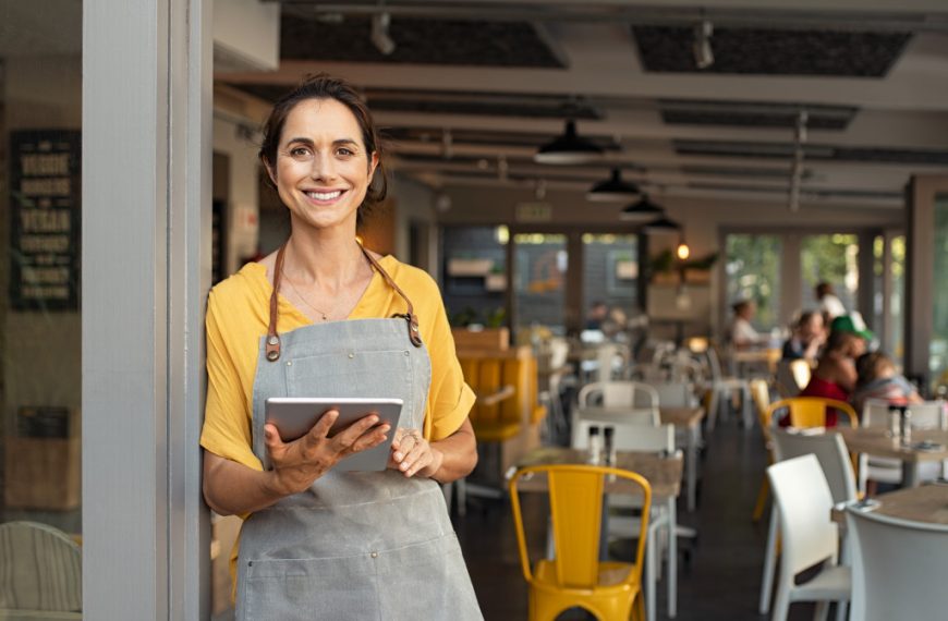 business owner standing at the restaurant entrance