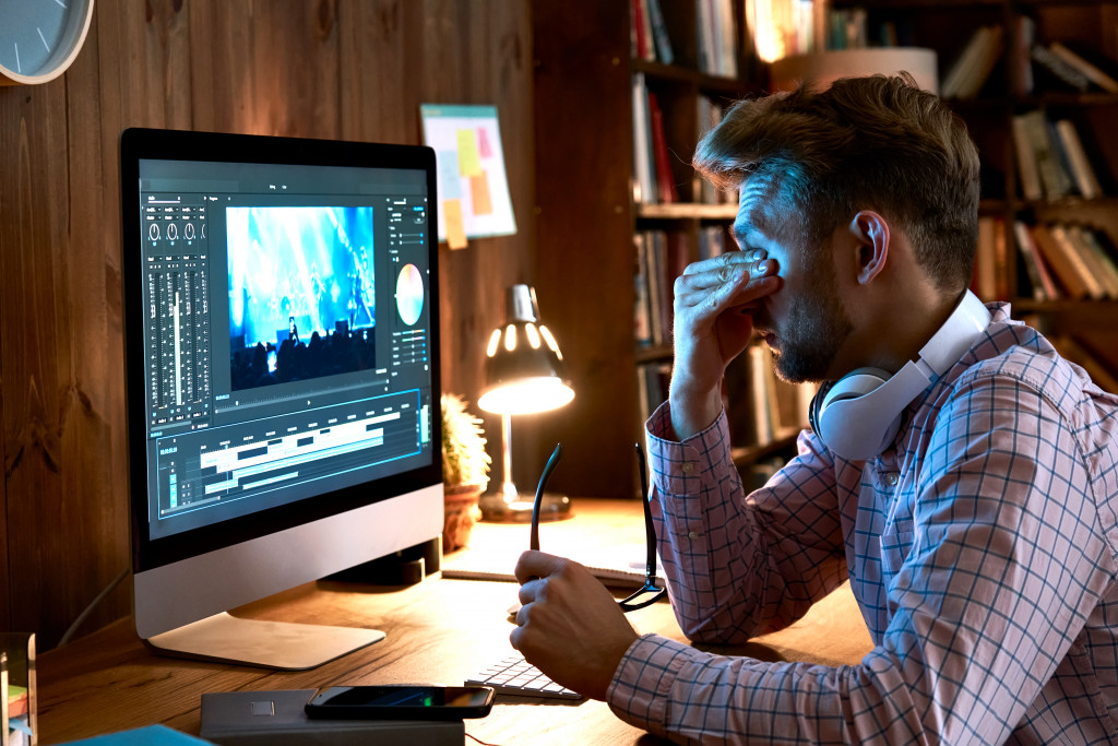 man with eye strain while working