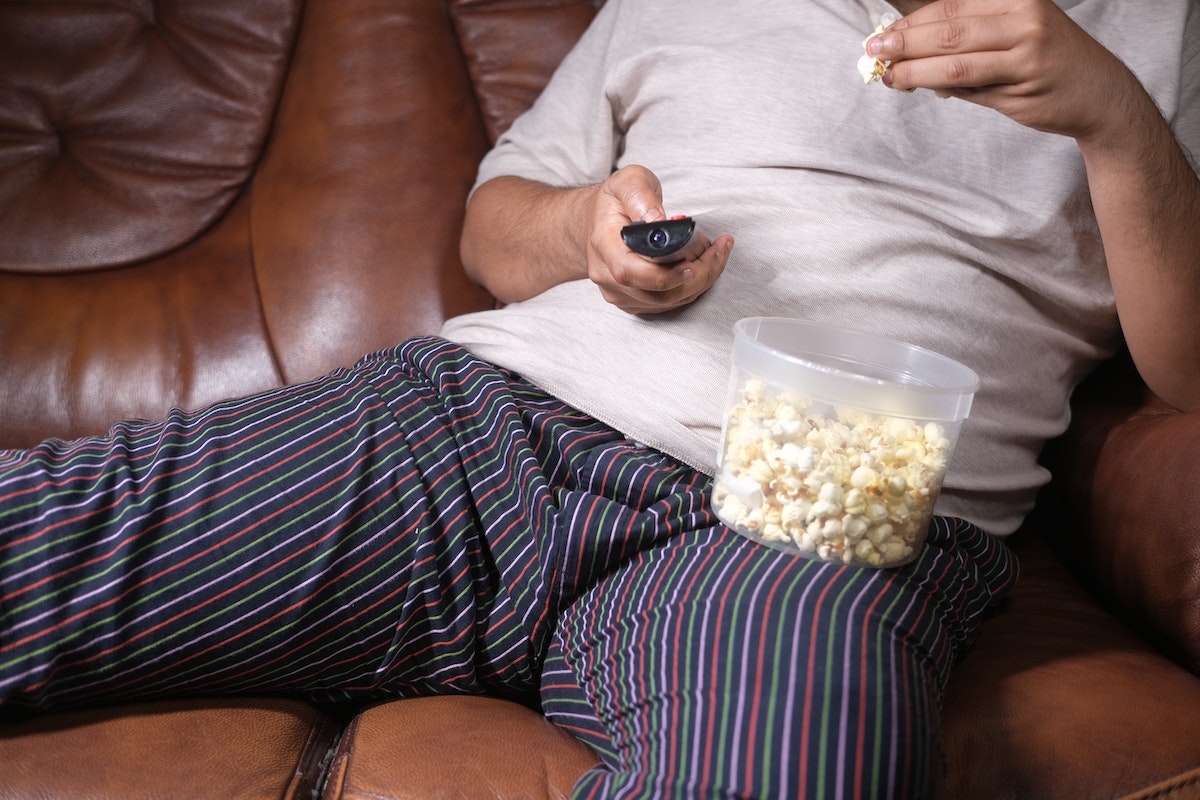 lousy man eating popcorn