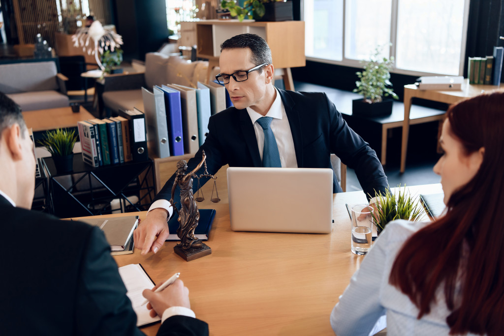 Business owners consulting a lawyer at an office.