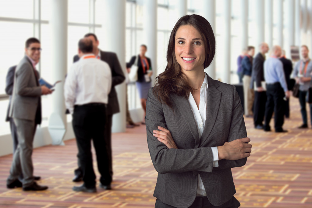 Female entrepreneur smiling while at a networking event.