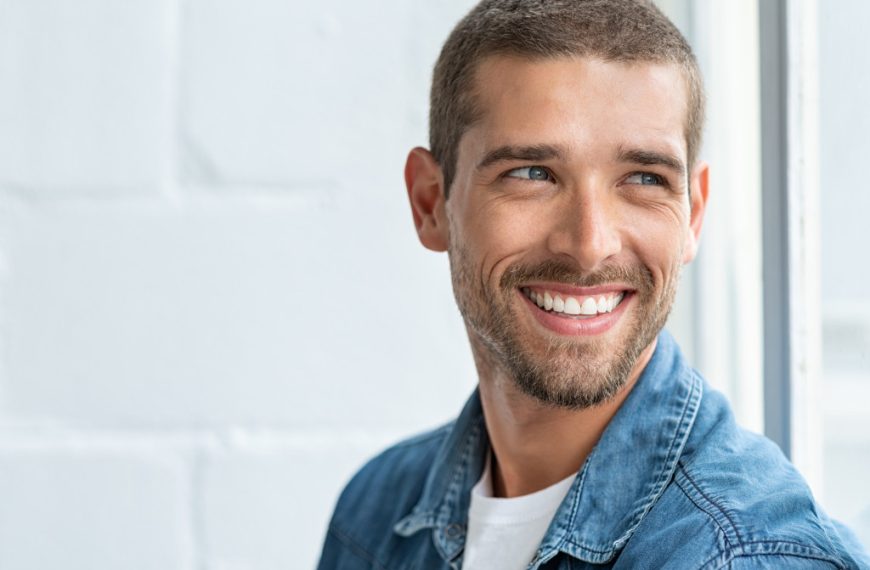 A handsome man smiling to the camera