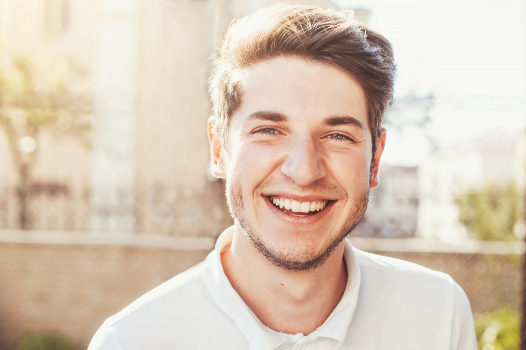 Smiling man outdoors and going about