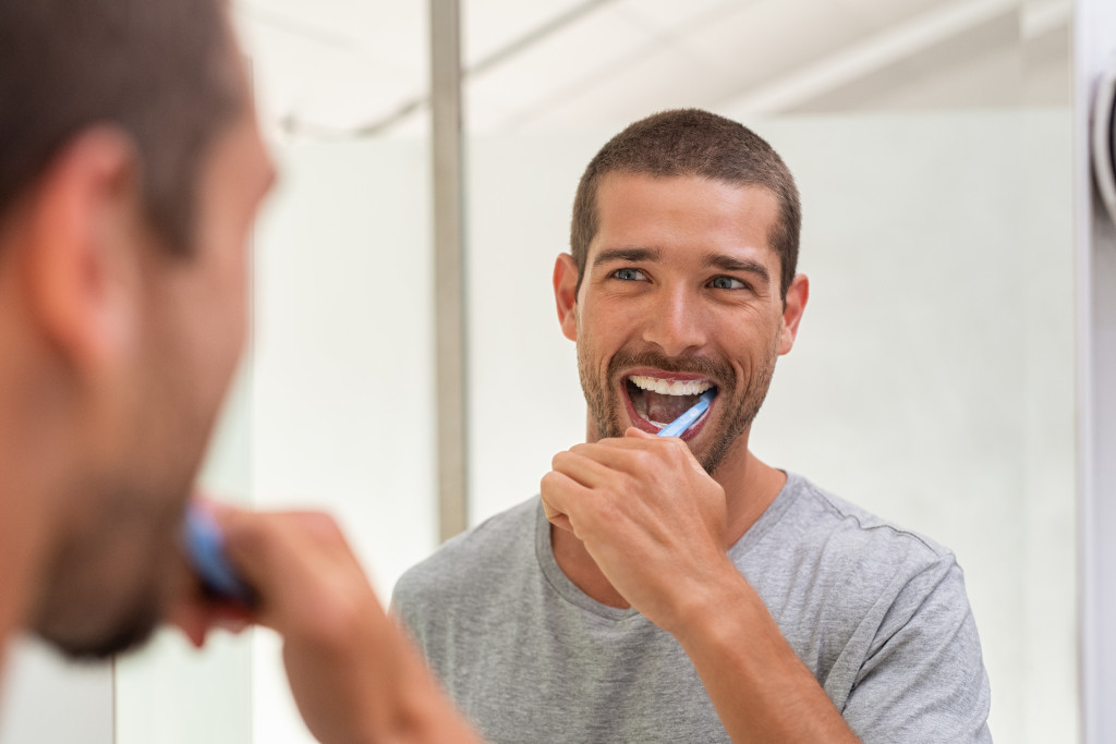 Man brushing his teeth at night