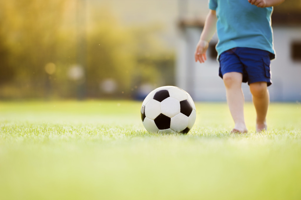 little boy playing football