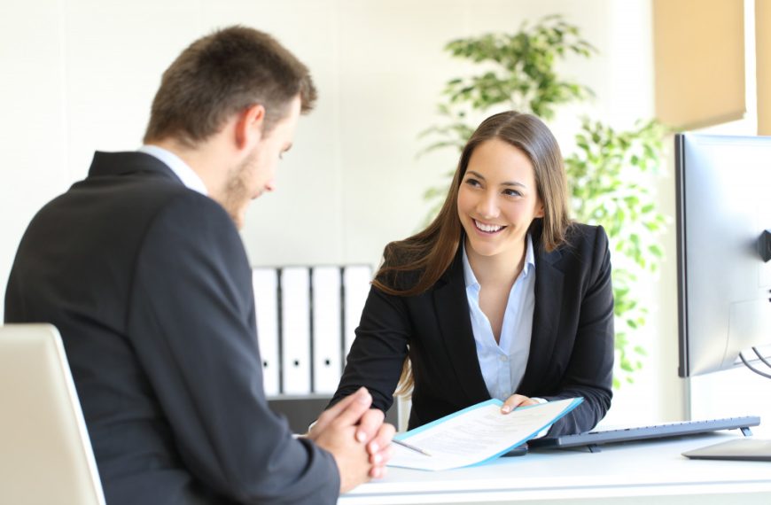 woman smiling talking to her male employee
