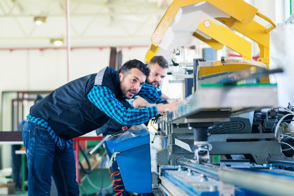 2 men looking at a machine in the manufacturing business