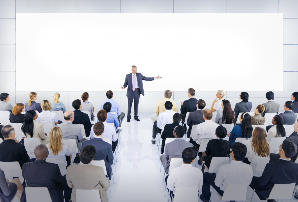 Business executive training employees in a conference room.